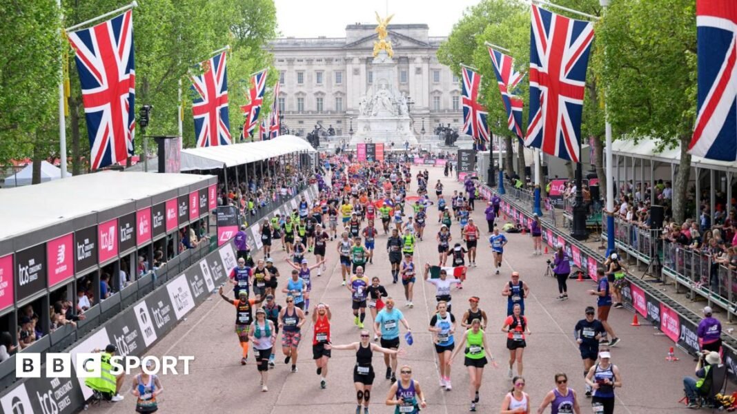 Runners make their way down The Mall to the London Marathon finish line