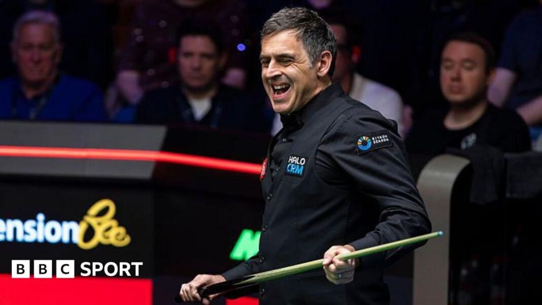 Ronnie O'Sullivan grimaces while holding his cue