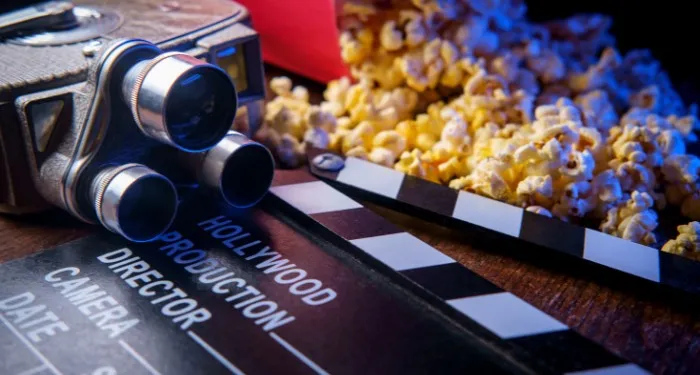 movie theater popcorn, a clapboard, and a video camera
