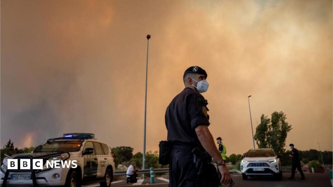 Firefighters struggle to contain Madrid wildfires, as more than 160,000 A person runs as the fire spreads in the mountains of Navaluenga, Avila, Spain